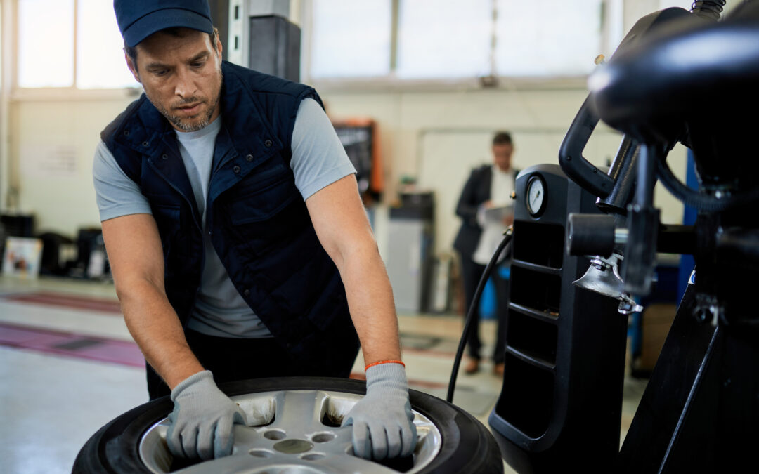 man performing tire alignment