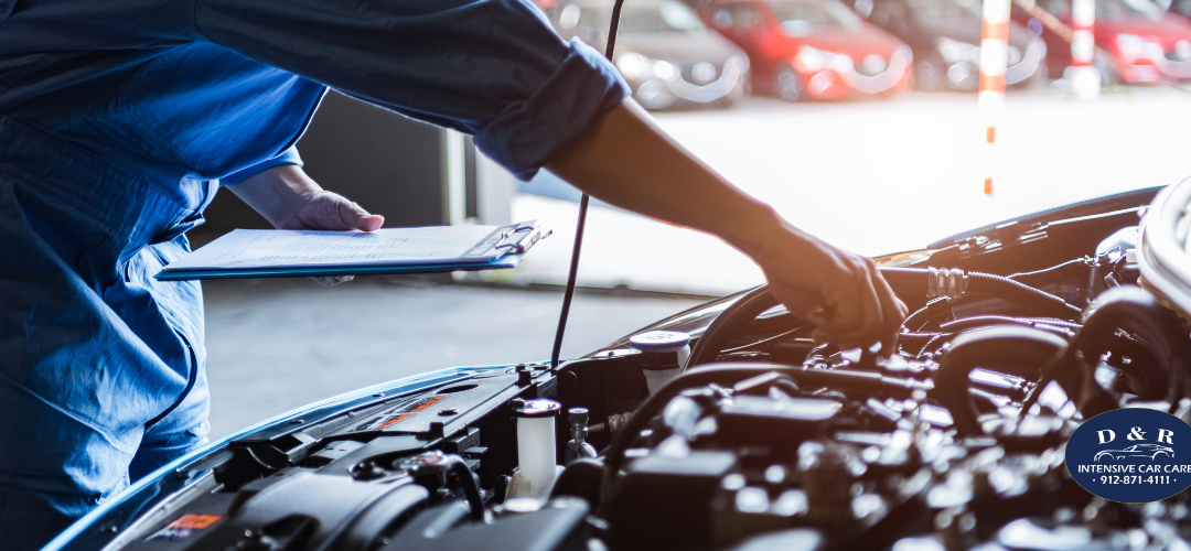 mechanic changing transmission fluid